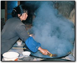 Li's wife cooking up a storm in the kitchen, Five Fingers Guest House, Tiger Leaping Gorge